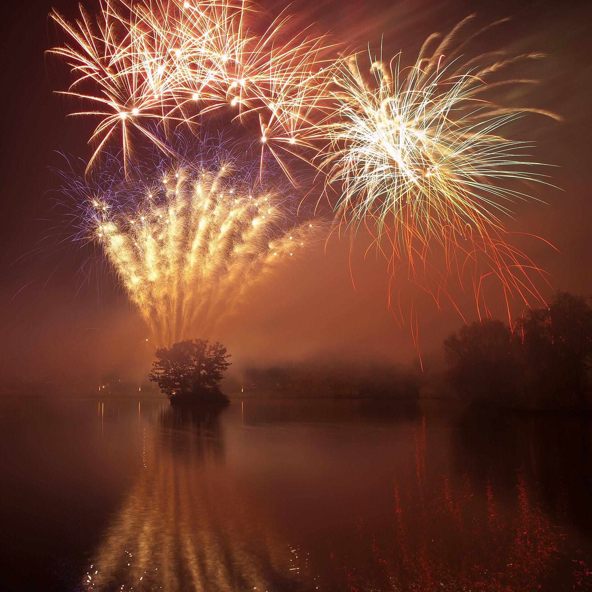 Fireworks display over a venue at night